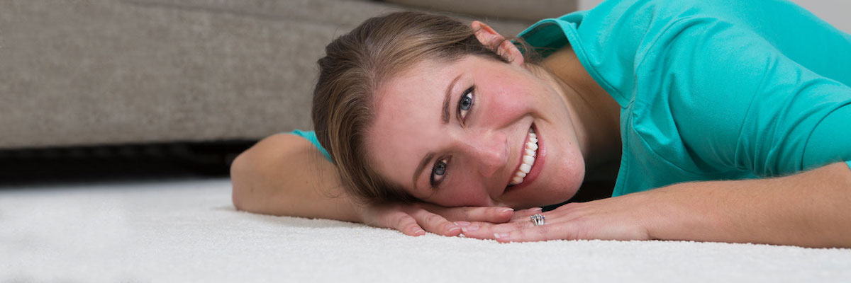 Woman relaxing on carpet cleaned by Chem-Dry of Rialto
